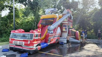Children play in a bounce house at the 2025 National Night Out.