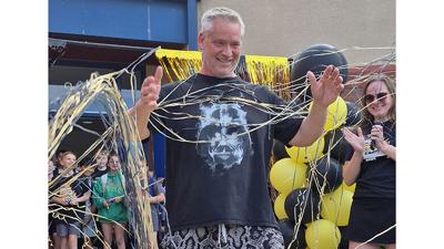 Guffey Elementary School archery coach John Ponzar on April 16 is covered with streamers as more than 100 students and parents surprised him after practice with the announcement that he has been named the 2026 NASP (National Archery in the Schools Progr...