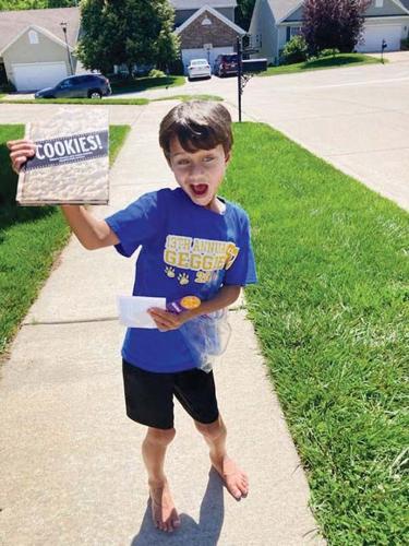 Logan Cannon, 8, found a book about baking cookies during one of Kristina Presley’s scavenger hunts.
