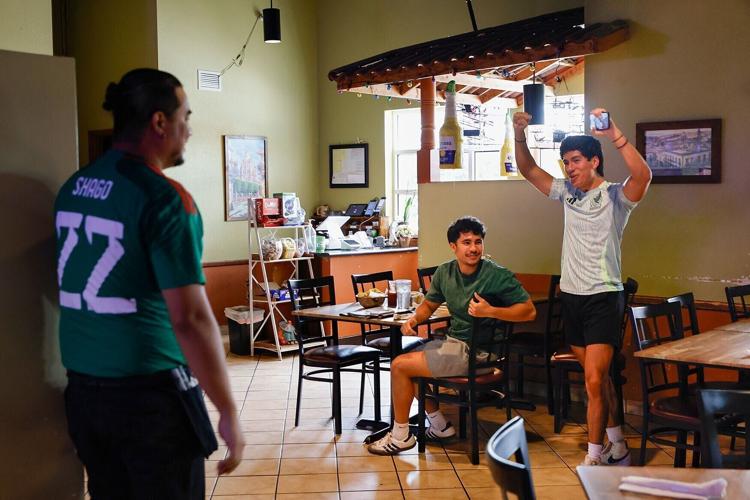 braham Ramirez, right, and Donovan Metz, center, celebrate