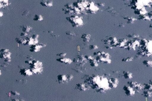 This handout satellite image released by Planet Labs PBC shows two vessels conducting what appears to be an offshore cargo transfer off the southeast coast of the Malay Peninsula near Singapore on March 24