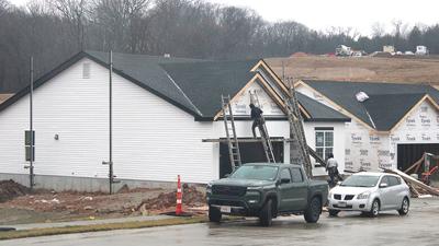 Construction workers work on a home near the main entrance of the Bella Terra subdivision off Vogel Road, just south of Arnold.