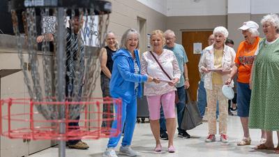 Dianna Wright of Crystal City tries disc golf at the De Soto Senior Expo.