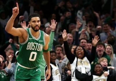 Jayson Tatum celebrates scoring in Boston's win over Dallas after making his first start since suffering an Achilles injury 10 months ago