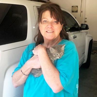 Sue Ziegler holds a kitten rescued May 28 from the engine block of her SUV.