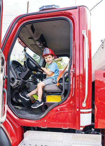 Barrett Gregory, 3, of Pacific explores a firetruck at the BackStoppers event.