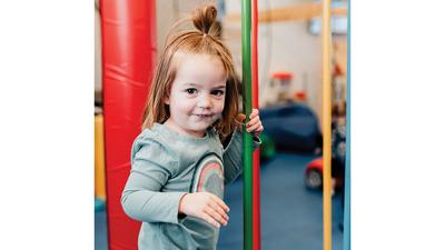 Dani Magistri enjoys play equipment in the We Rock the Spectrum Kids Gym her parents recently purchased.