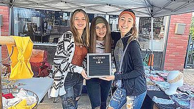Paige Drury, right, in her booth at the 2022 Twin City Days craft fair with friends Shelbie Sullens, left, and Lillie Reeder.