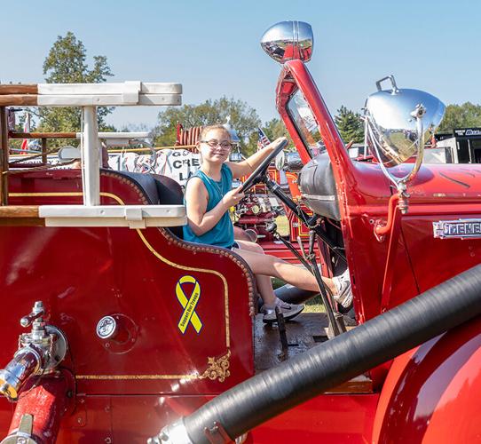 Amelia Vandeven, 10, of Barnhart makes herself at home in a vintage firetruck.