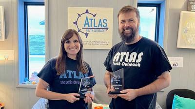 From left, Annie Caputa, Atlas Youth Outreach executive director of clinical programs, and Jeff Elden, executive director of operations, hold their Overall Mental Health Champions awards given by the Jefferson County Mental Health Summit.