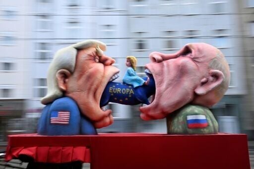 Sculptor Jacques Tilly's portrayal of Presidents Donald Trump and Vladimir Putin (R) feasting on a small blonde woman marked 'Europe'
