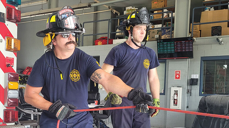 Saline Valley Fire Protection District firefighters Nick Blementhal, left, and Chris Bueltmann train on using rope to pull a patient from an embankment.