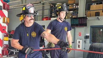 Saline Valley Fire Protection District firefighters Nick Blementhal, left, and Chris Bueltmann train on using rope to pull a patient from an embankment.