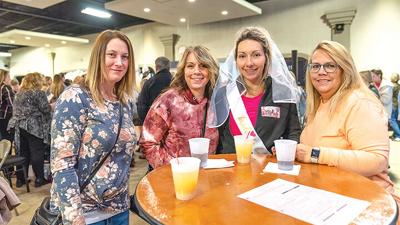 From left, a group from Hillsboro, Julie Turner; Angie Allen, mother of the bride; Brittany Ennis, bride-to-be; and Robin Turner visit last year's Leader Wedding Fair.