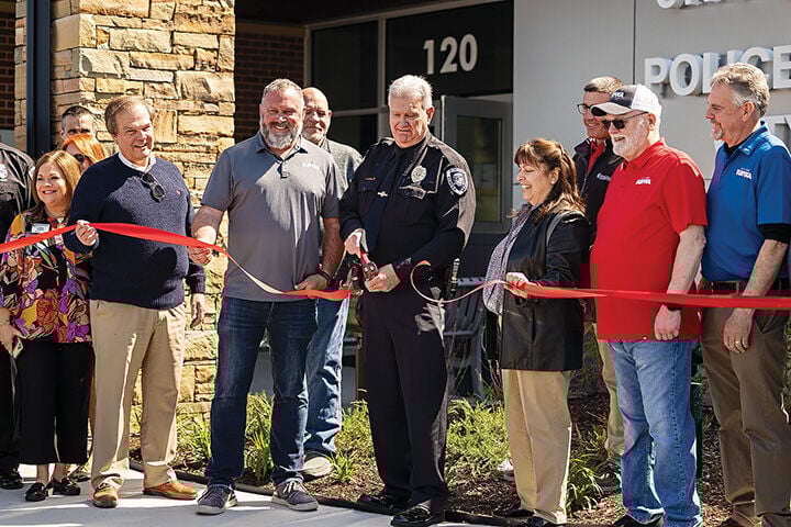 Police Chief Michael Wiegand cuts the ribbon with prominent members of the Eureka community.