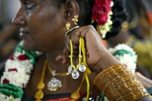A member of the transgender community holds "thali", a sacred thread symbolising marriage to Hindu warrior god Aravan