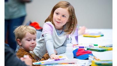 Madison Crowley, 6, of Arnold and her brother, Eli, 3, complete coloring sheets during a lesson on great American musicians at the Jefferson County Library’s Arnold branch.