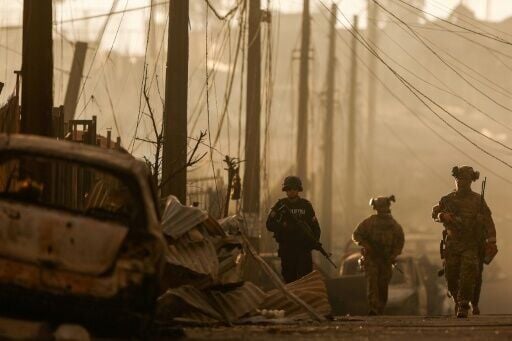 Chilean soldiers patroled among the damage after a wildfire in Concepcion