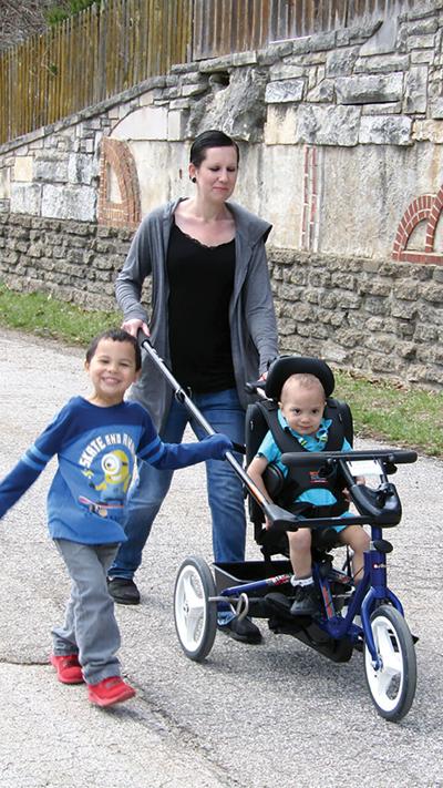 Brittany Bonds pushes Phoenix Bonds in Rifton Adaptive Tricycle