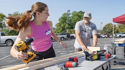 Emma Keithly, 14, and her dad, Brian Keithly, of Eureka help assemble children’s beds.