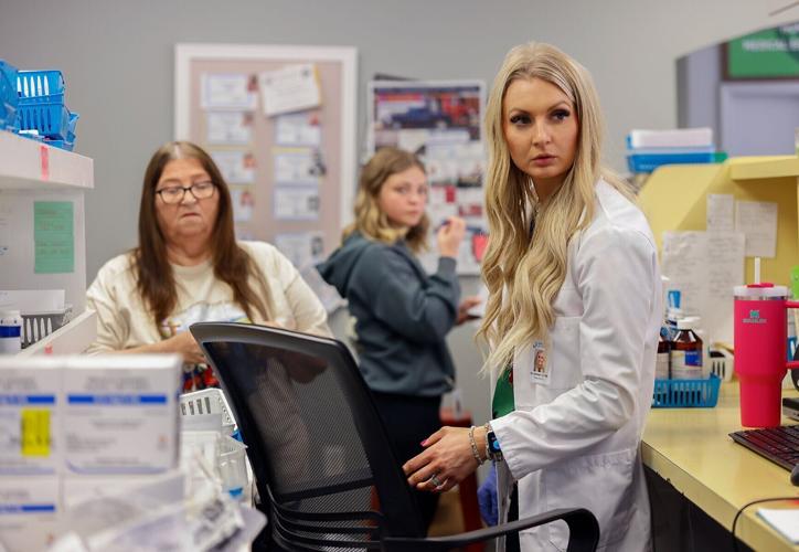 Pharmacist Katelyn White works behind the counter