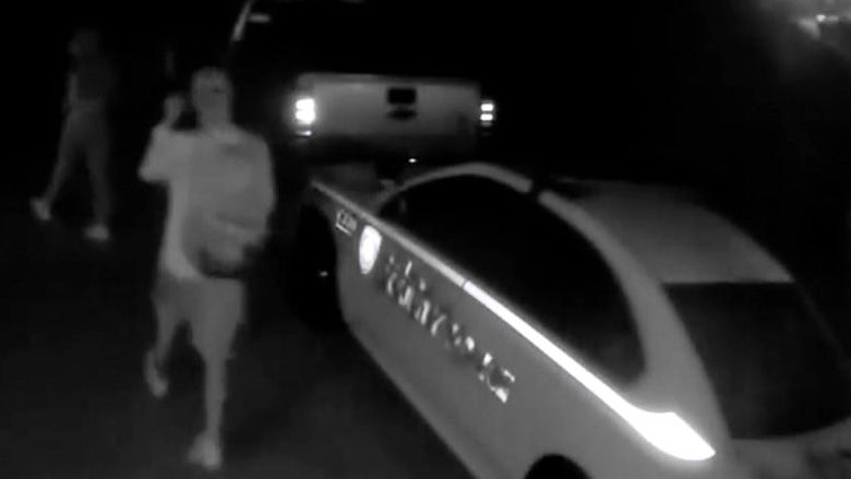 Surveillance footage appears to show a man near a St. Louis County Police car that was vandalized.