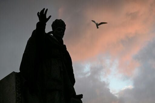 A statue of Pope Benedict XV outside Istanbul's Cathedral of the Holy Spirit where Leo attends prayers on Friday