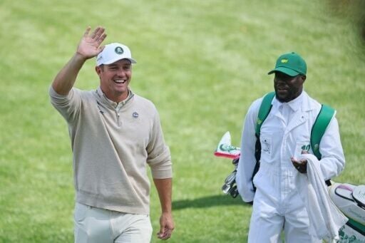 Two-time US Open champion Bryson DeChambeau waves alongside actor and Par-Three Contest caddie Kevin Hart on the eve of the 90th Masters at Augusta National