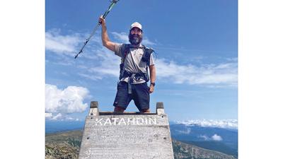 John Leech completes his hike, which took over four months, atop Mt. Katahdin in Maine.