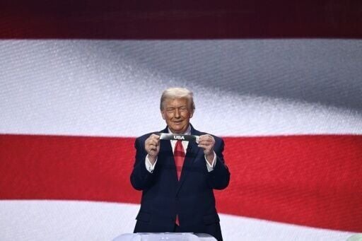 President Donald Trump holds up the card for co-hosts USA at the 2026 World Cup draw