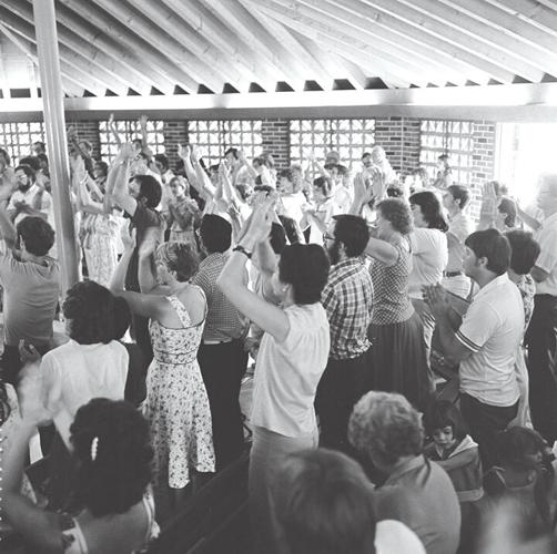 Church members, pictured in the late 1970s, worship at Christian Outreach Church.