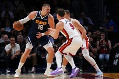 The Denver Nuggets were left sweating on a knee injury to star forward Nikola Jokic (left) after a blowout loss to Miami