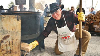 Greg Pfeiffer of the Kimmswick Historical Society tends to the apple butter pot fire during last year’s Apple Butter Festival.