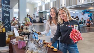 From left, Emily Adams and Kristina Marchand, both of Imperial, try a mini bundt cake at the Nothing Bundt Cake booth at the Wedding Fair last year.