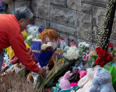 A community member places flowers at a makeshift memorial near the Covenant School, March 29, 2023