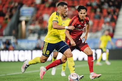 Nashville SC's Cristian Espinoza dribbles upfield against Toronto FC
