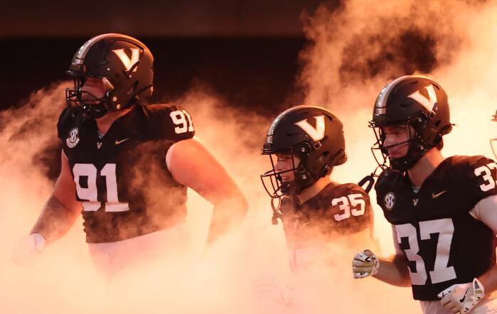 Cade McConnell (No. 70), teammates take the field at FirstBank Stadium