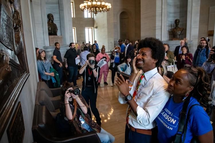 Rep. Justin Pearson weeps alongside his mother while looking at a sculpture depicting African American men casting ballots after winning the right to vote, May 5, 2026