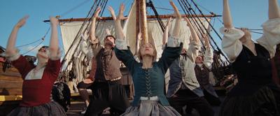 A scene of Quakers dancing on the deck of a ship from the movie ‘The Testament of Ann Lee.’