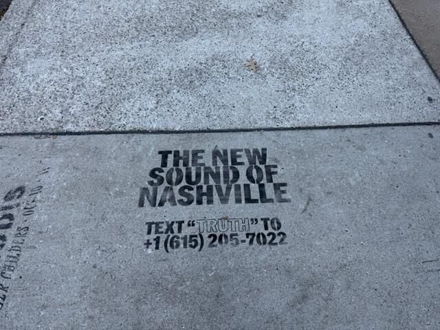 Photo of the sidewalk outside East Nashville venue The 5 Spot, with an ad for forthcoming venue The Truth spraypainted on it. The ad reads “The New Sound of Nashville Text “TRUTH” to (615) 205-7022”