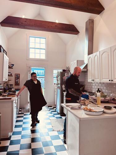 Two chefs working in a home kitchen