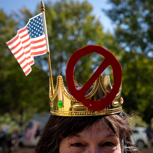 A woman wearing a "no kings" crown
