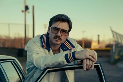 Morgan Wallen press photo 2025 artist leans on open door of a car