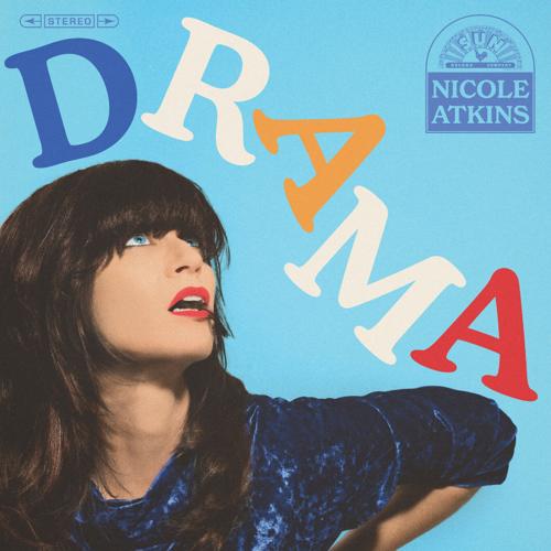 Cover art for Nicole Atkins' 2026 album 'Drama,' featuring the artist in a dark blue top on the bottom left corner looking up at the title as it outlines her head and arm.