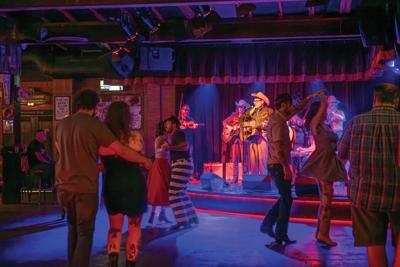 Couples dance to Chris Scruggs and the Stone Fox Five at Skinny Dennis