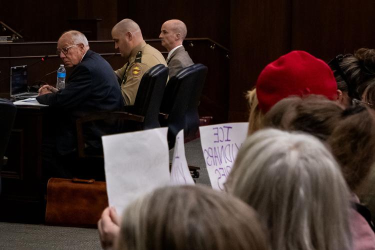 Tennessee Commissioner of Safety and Homeland Security Jeff Long testifies at the state legislature while onlookers protest, Feb. 26, 2026
