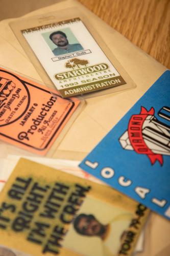 Detail photograph of items from the archives at the Center for Popular Music, featuring array of backstage passes issued to longtime live production professional Stephen Gudis