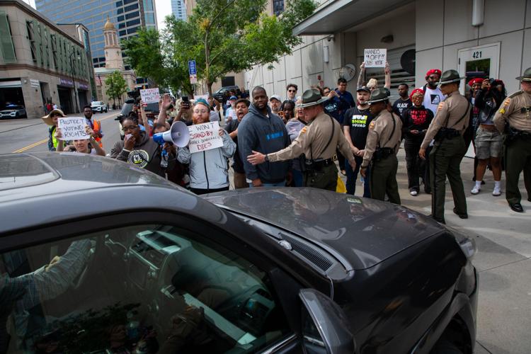 Members of the Tennessee Highway Patrol hold back protesters attempting to block lawmakers' entrance to the state Capitol, May 5, 2026