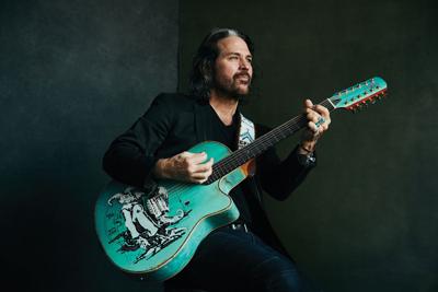Kip Winger press photo artist plays a seafoam green 12-string guitar