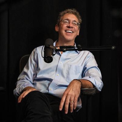 Lee C. Camp sits at a microphone